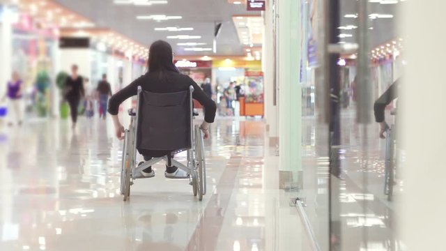 Woman with a disability in a wheelchair going to the Mall
