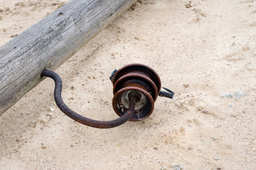 An old wooden power pole lying on the ground. Broken electrical network.