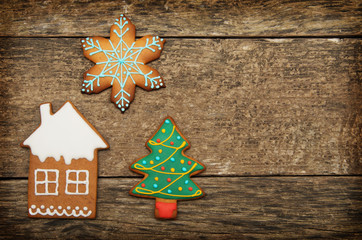 Gingerbread cookies over wooden background