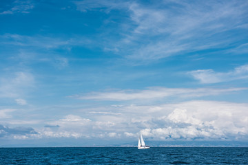 Fototapeta premium Yacht with white sails in the open sea