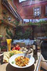 sunlit plate of Italian pasta