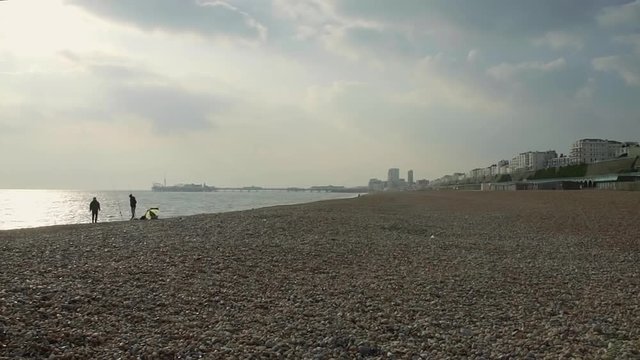 Couple of guys fishing at the Brighton beach - 50% speed