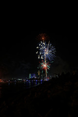 Fireworks explode over the Des Moines skyline. The Financial Center and EMC buildings are lit up for the Independence Day holiday.