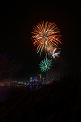 Fireworks explode over the Des Moines skyline. The Financial Center and EMC buildings are lit up for the Independence Day holiday.