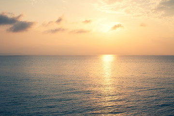 Sunset Sea over the Horizont. Beautiful Ocean Sunshine Landscape, Shimmering Twilight with yellow...
