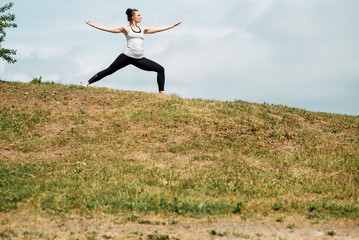 Young girl doing yoga in morning park.Woman Yoga - relax in nature