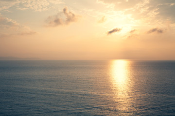 Sunset Sea over the Horizont. Beautiful Ocean Sunshine Landscape, Shimmering Twilight with yellow colors, Warm marine dusk Sun, Reflecting sunlight over the water