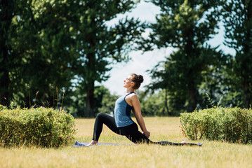 Young girl doing yoga in morning park.Woman Yoga - relax in nature