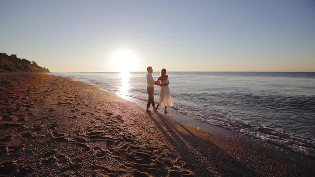 Romantic young couple enjoying beautiful sunset walk on the beach travel vacation, Krabi Thailand