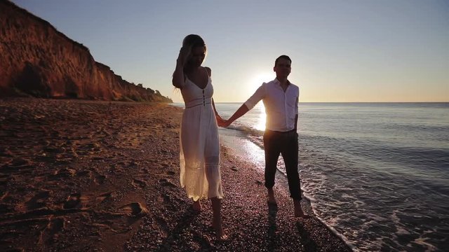 Romantic young couple enjoying beautiful sunset walk on the beach travel vacation, Krabi Thailand