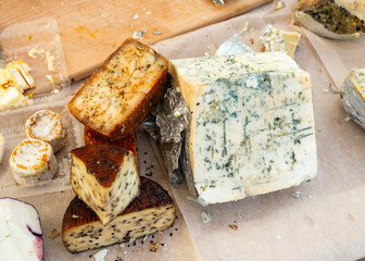 Cut cheese with mold of different varieties on the table