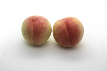 Two peaches isolated on white background.