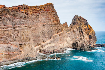 Fototapeta na wymiar Red cliffs and blue sea at San Lorenzo cape on Madeira island