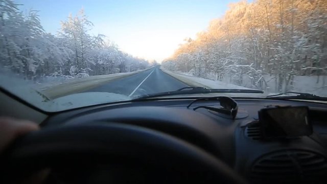 man slowly driving a car on a winter road. In winter, the majority of motorists still goes slow down and be careful.