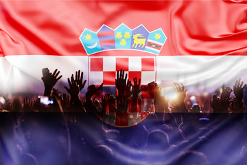 football supporters with raised hands against Croatia flag - crowd in stadium celebrating victory