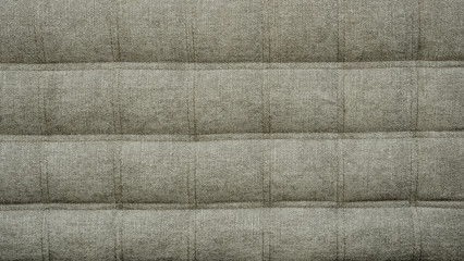 Fototapeta premium Coach type cloth matting screed tightened with buttons. Natural chesterfield style quilted upholstery backdrop close up. background texture