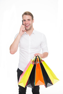 Guy buy clothes online. Online shopping concept. Take advantages online shopping and delivery. Man call to order more items. Man happy holds bunch of bags speak on phone with consultant