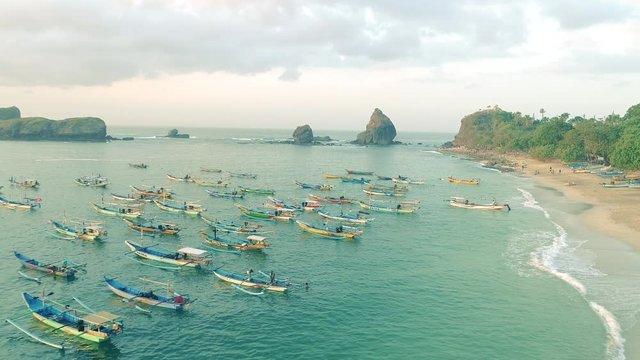 Indonesia traditional fishing boats docked in shores after fishing an aerial view, Papuma beach Jember