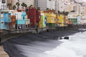 Fototapeta na wymiar Colorful houses in San Cristobal fishing town near Las Palmas, Gran Canaria. Urban area by the sea in Canary Islands, Spain