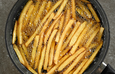 frying french fries © Mara Zemgaliete