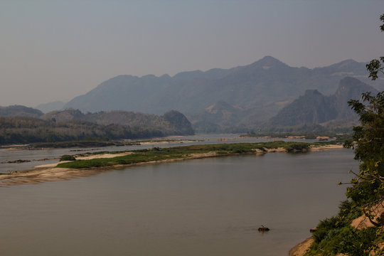 A mahout washing his elephant in the Mekong river in the democratic people's republic of Laos