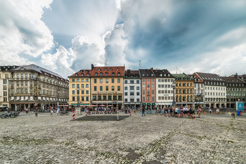 Fototapeta premium Munich, Germany June 09, 2018: Old houses in the city of Munich at the Residenzstrasse, Germany. People walk through the streets of Munich.