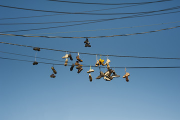 Old Worn Sneakers Hanging On Telephone Wires