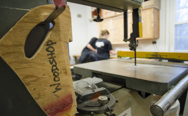 Woodworker's push stick with students in background