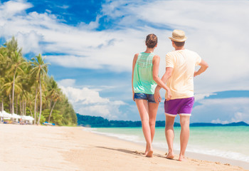 young couple on their honeymoon having fun by tropical beach