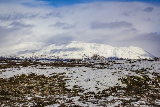 Clouds Passing over a Snowy Mountain Peak with Tundra in the Foreground in the Golden Circle of Iceland
