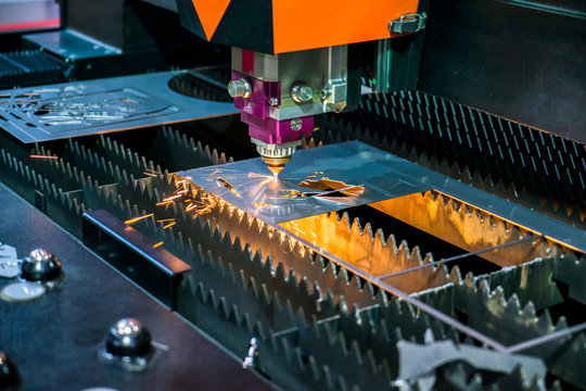 Head of Laser cutting of metal sheet with sparks