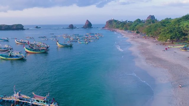 Indonesia traditional fishing boats docked in shores after fishing an aerial view, Papuma beach Jember