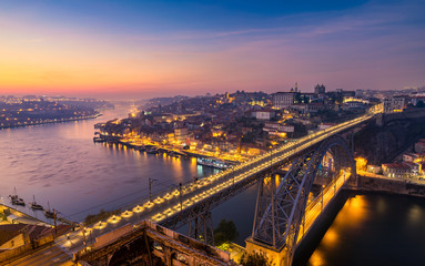 Fototapeta na wymiar Porto panoramic aerial view of Dom Luis Bridge at sunset. Porto, Portugal. Cityscape of Porto downtown touristic Ribeira