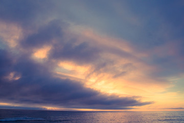 Naklejka na ściany i meble Idyllic ocean at sunset with sea, sky and sun 