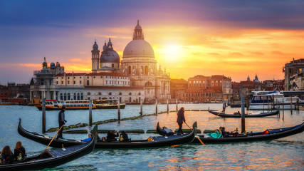 Fototapeta na wymiar Sunset in Venice. Image of Grand Canal in Venice, with Santa Maria della Salute Basilica in the background. Venice is a popular tourist destination of Europe. Venice, Italy.