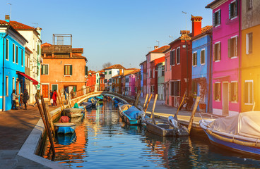Fototapeta premium Lovely house facade and colorful walls in Burano, Venice. Burano island canal, colorful houses and boats, Venice landmark, Italy. Europe