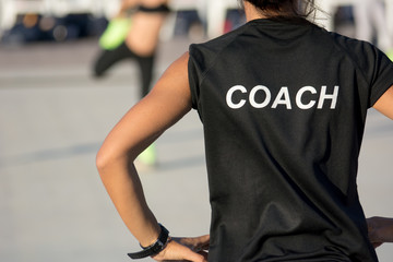 Horizontal View of Skater Coach on Blur Girls Skating Background at the Skating School