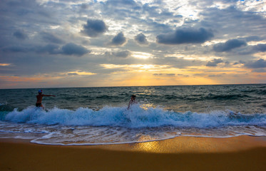 Phuket: 21 March 2017 Children, Parents Come and play the sea with the light blue moon (Mai Khao Beach) Thailand.
