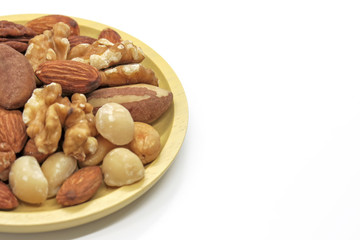 Mix of nuts in plate on white background