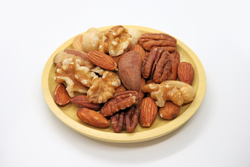 Yellow plate with mixed nuts