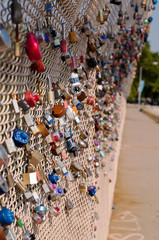 Locks signifying a couples love for one another on a bridge's chain fence in Pittsburgh,...