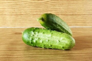 isolated green garden fresh cucumber on wooden background