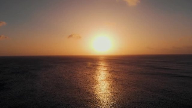 A beautiful sunset over a ocean filmed by a Drone