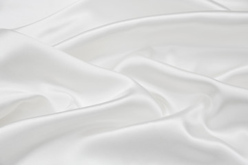 The texture of the satin fabric of white color for the background 