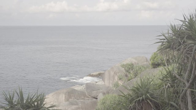 A quiet beautiful sea with a light wave near the island's shoreline shore. S-log, ungraded