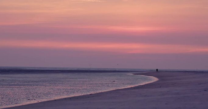 Gold hour sunset in Denmark Scandinavia Europe on beach with people walking