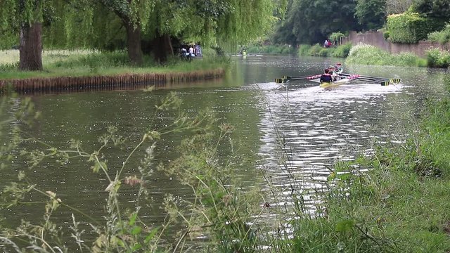 Young enthusiastic athletes training with canoes on the River Wey near Guildford in England.