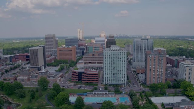 Push forward towards Shaw Park public swimming pool in Clayton Missouri with downtown Clayton in the background.