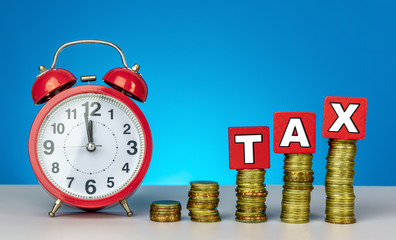 Time to pay TAX. Tax, taxation and Finance Concept with Stack of Coins - GST (Goods and Services Tax) written on