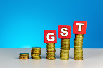 Tax and Finance Concept with Stack of Coins - GST (Goods and Services Tax) written on